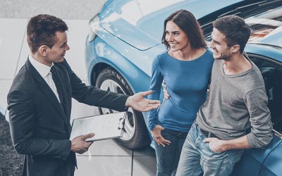Couple meeting with an auto dealer