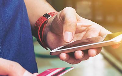 Woman using cell phone for banking