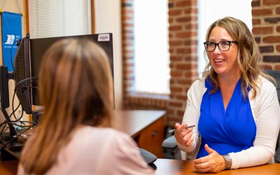 Carrie McNamara sitting with a business client