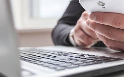 Business person using his phone for banking