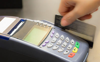 Person sliding a debit card