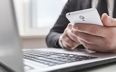 Person holding phone while banking