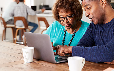 Man helping older woman with security issue