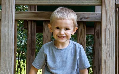 Child on a play set smiling