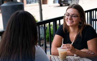 Young gals sitting at coffee shop