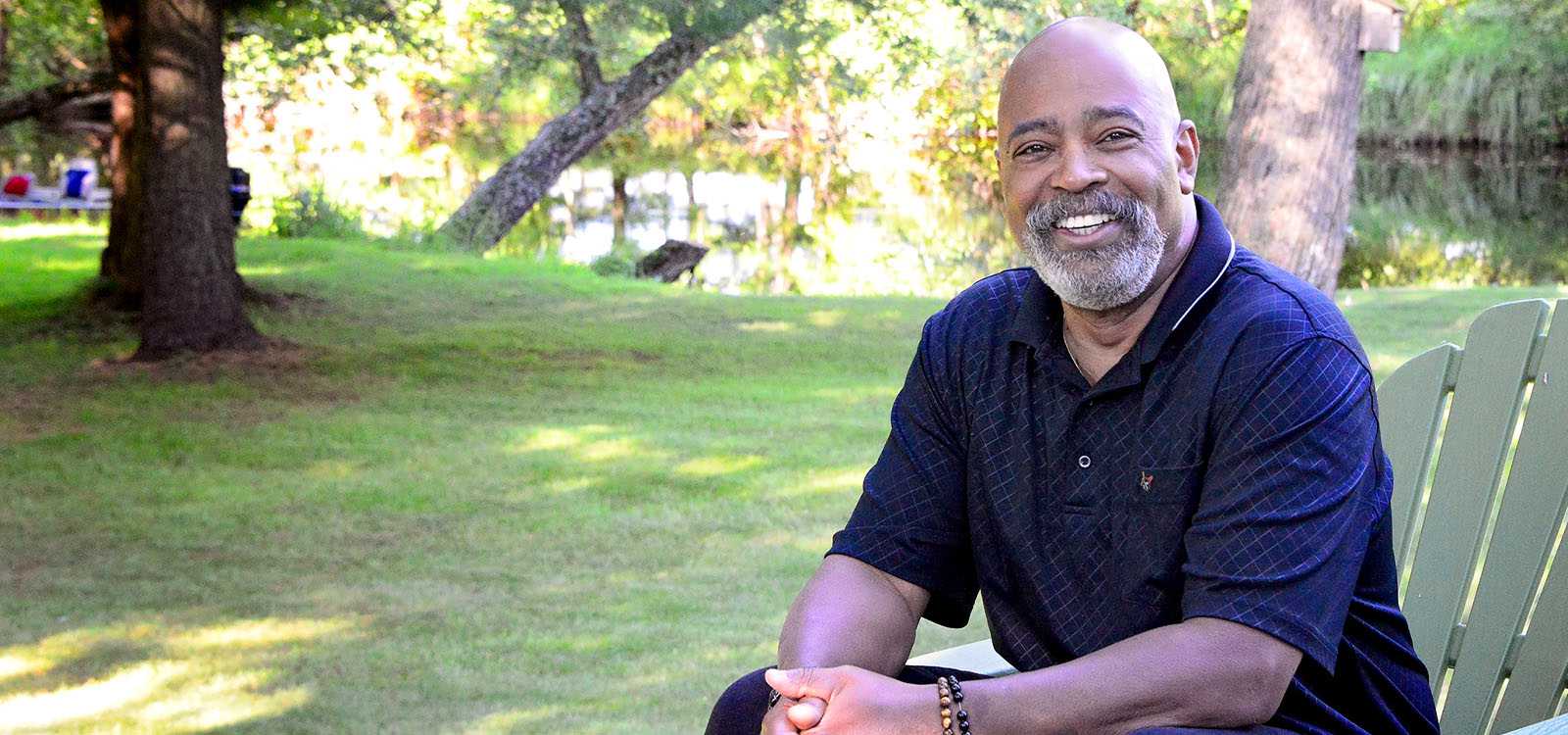 smiling man sitting outdoors