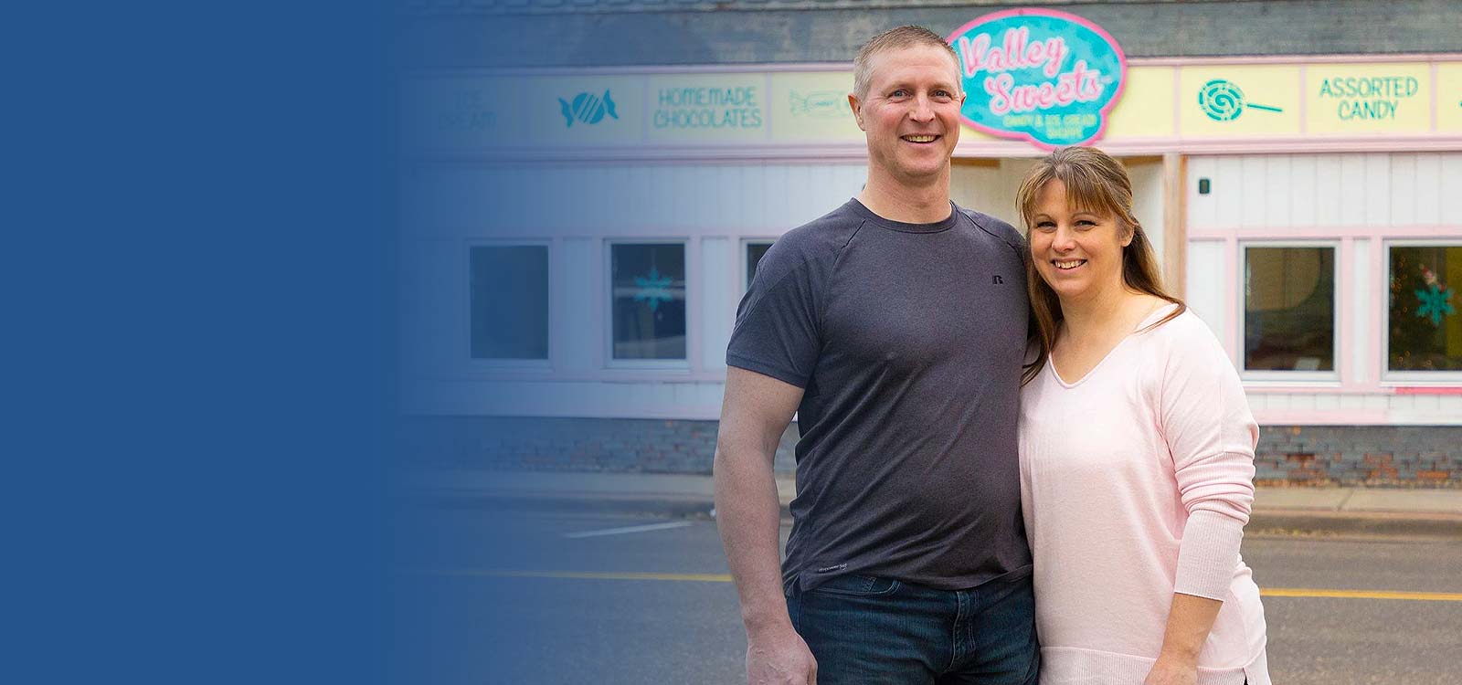 Couple standing in front of their business