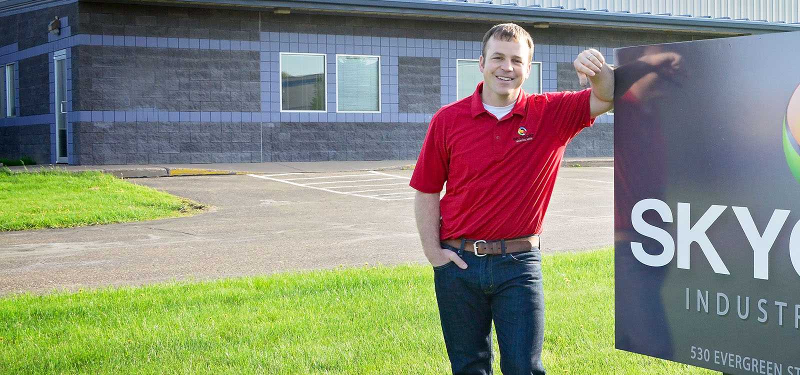 Man standing in front of his business