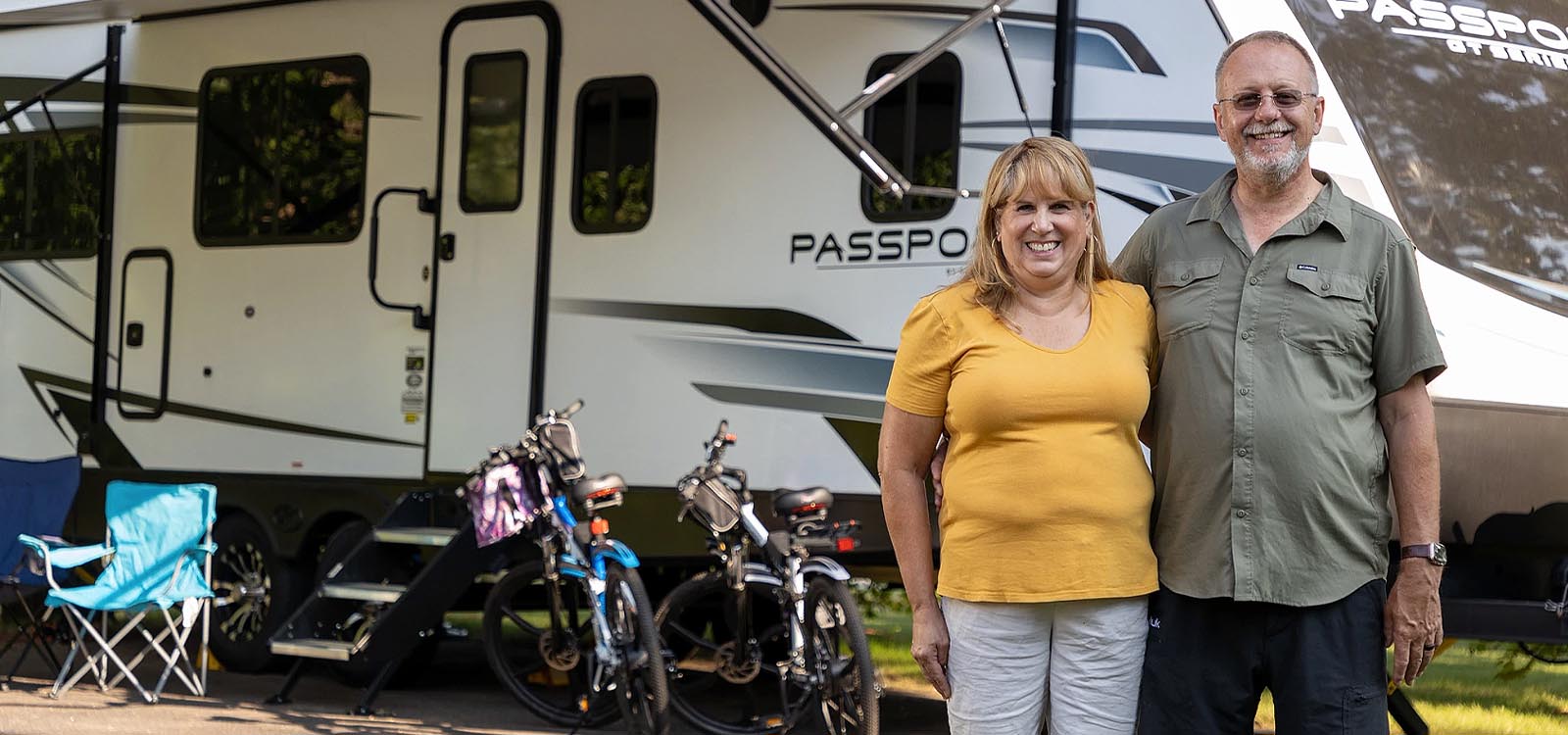 Couple in front of their RV