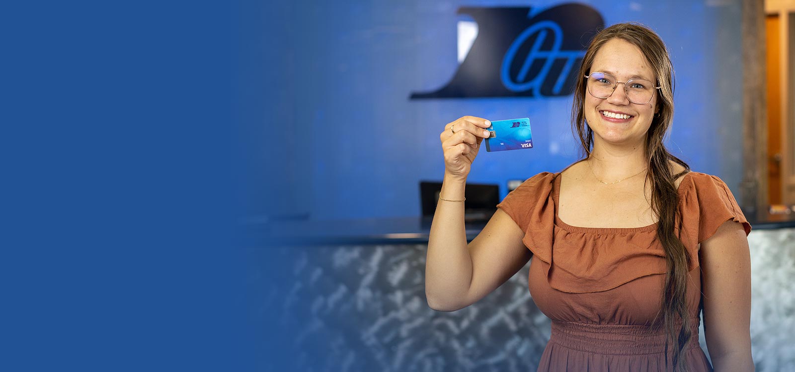 Woman holding a debit card and smiling