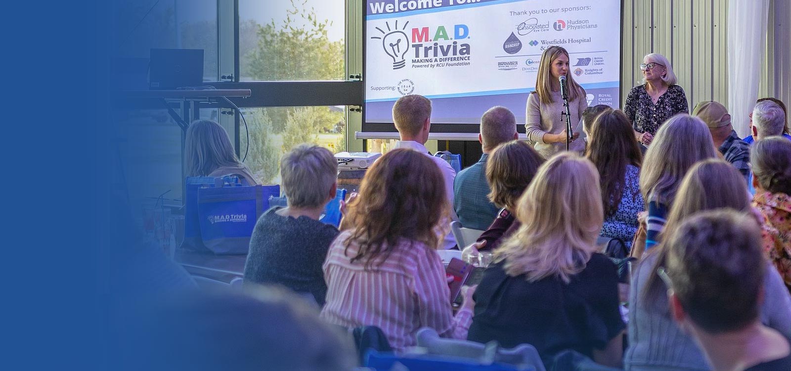 Woman speaking to a group about MAD Trivia