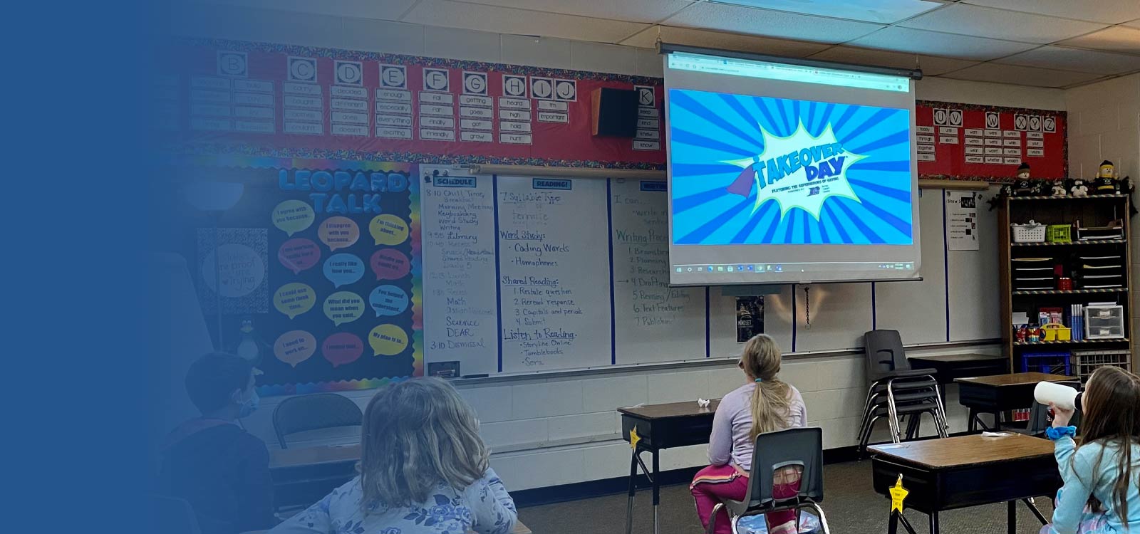 Classroom of kids with logo