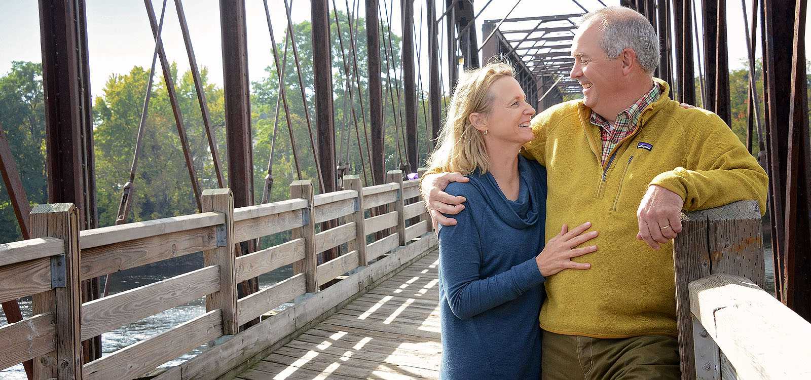 older man and woman on a bridge