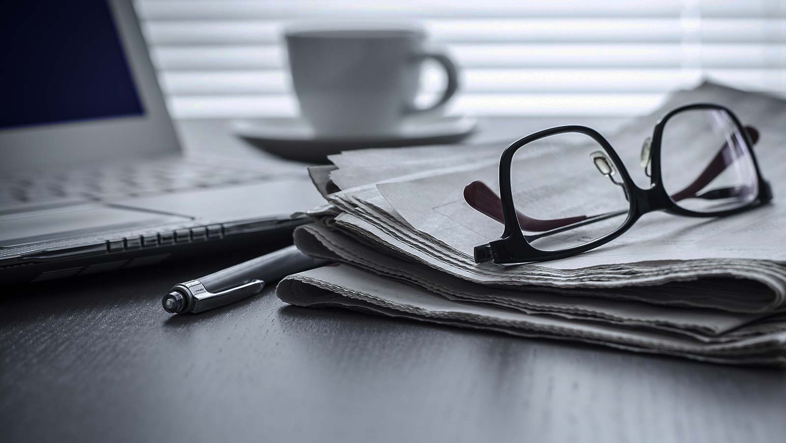 Glasses on a persons desk