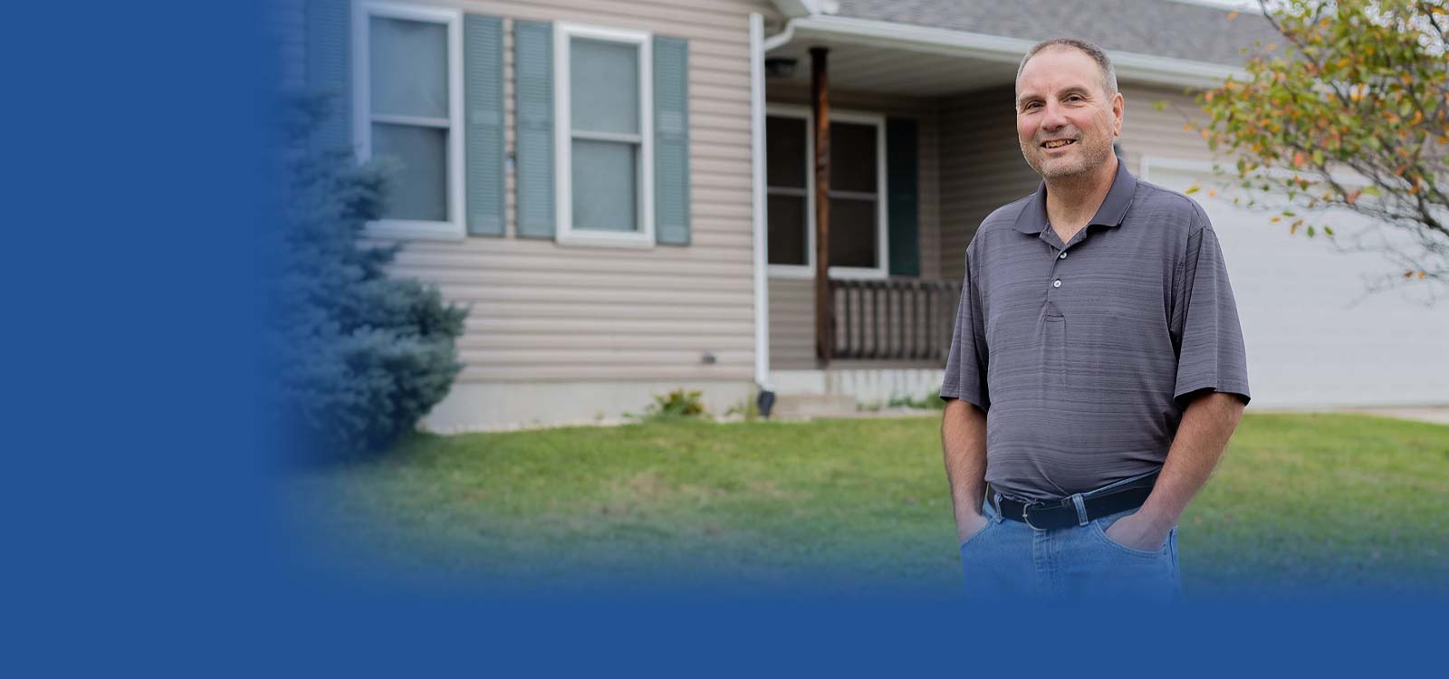 Man standing in front of his home