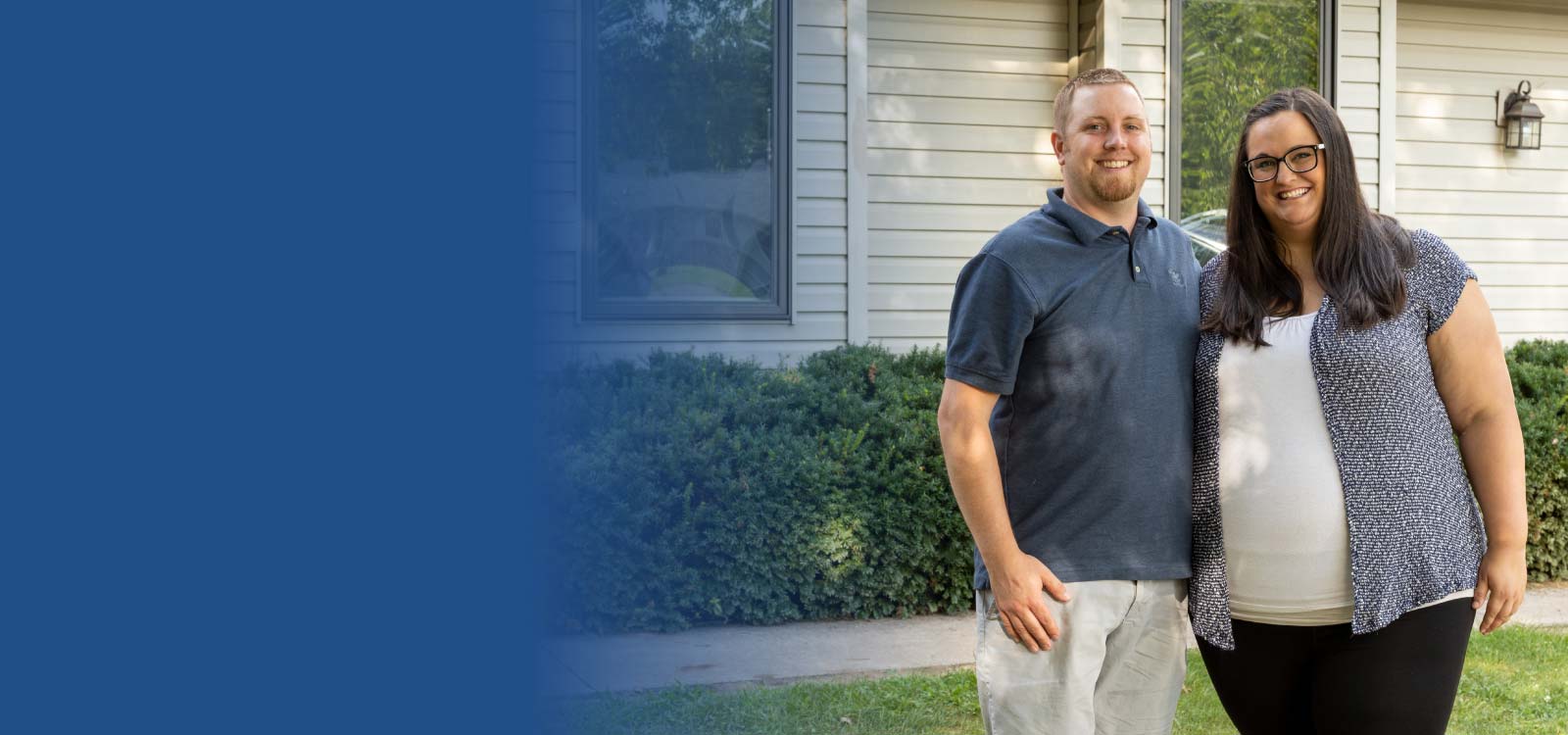 Couple standing in front of house