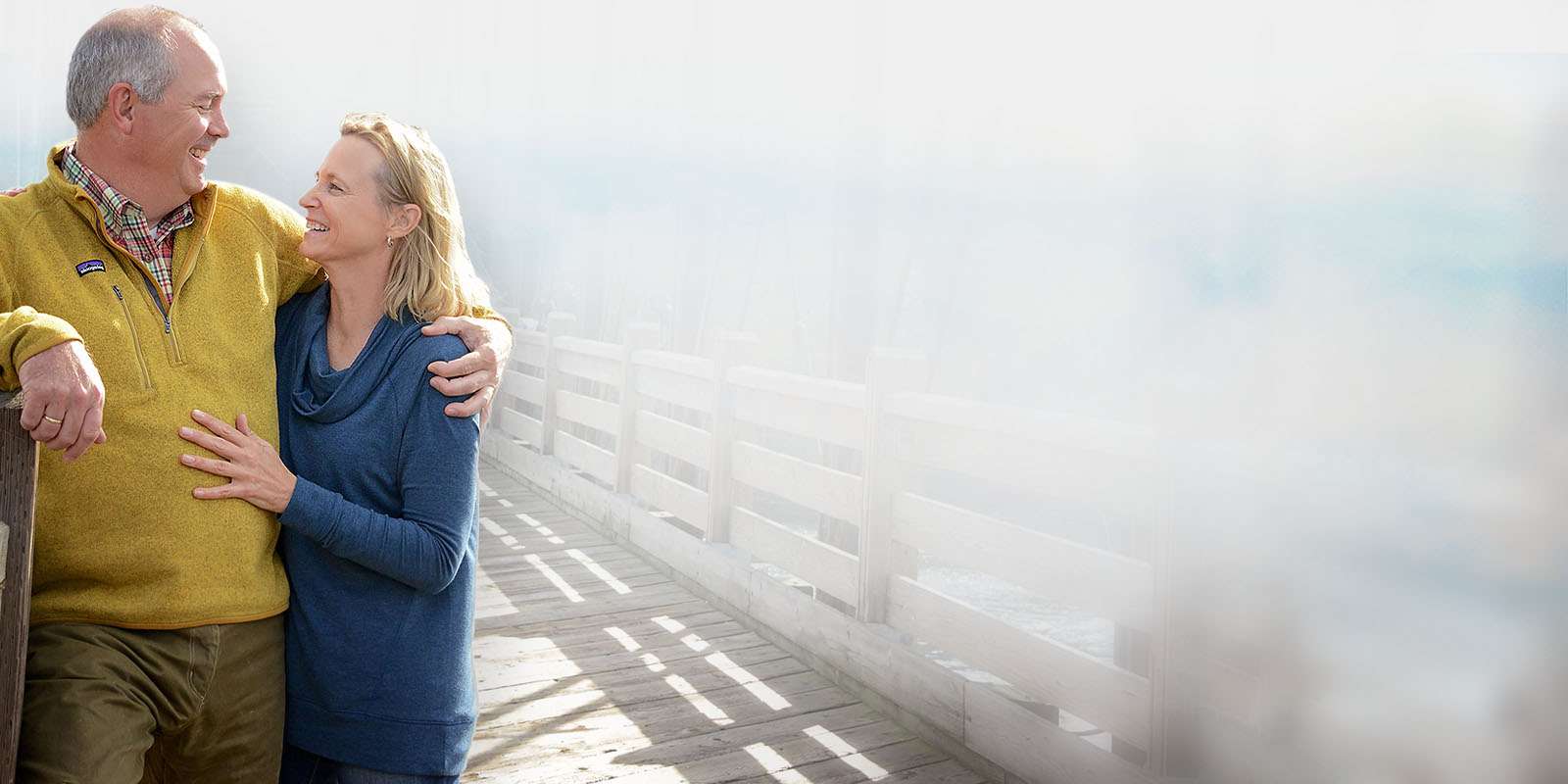 Couple standing on a bridge